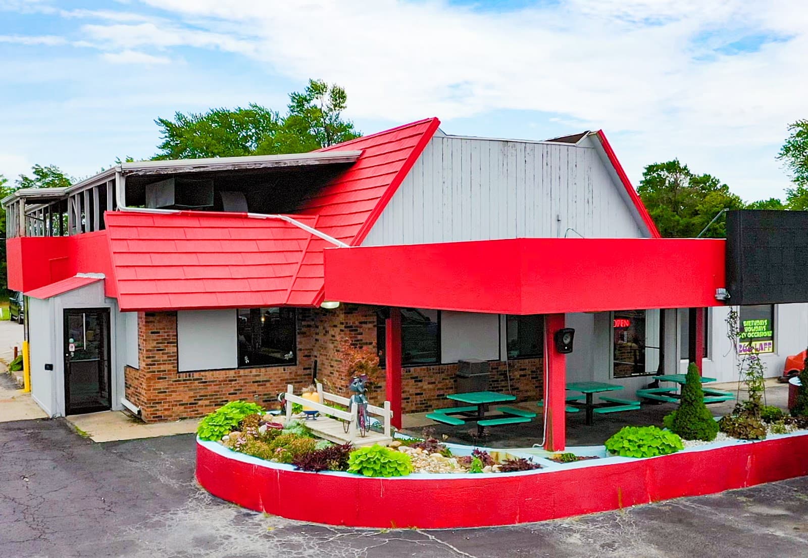 Funny Pages Cafe building with its red roof on North Morley Street