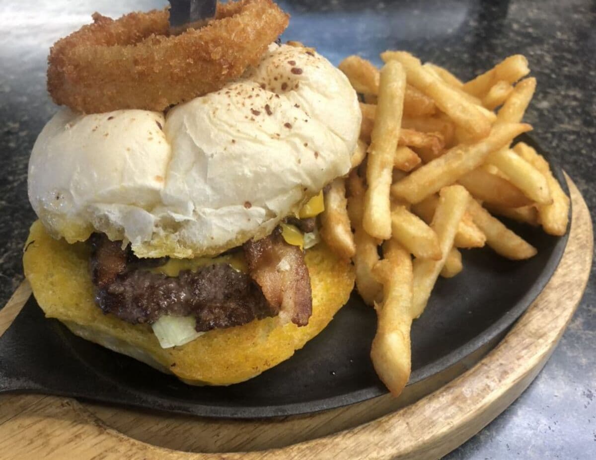 Double stacked hand pattied burger with fries at Funny Pages Cafe