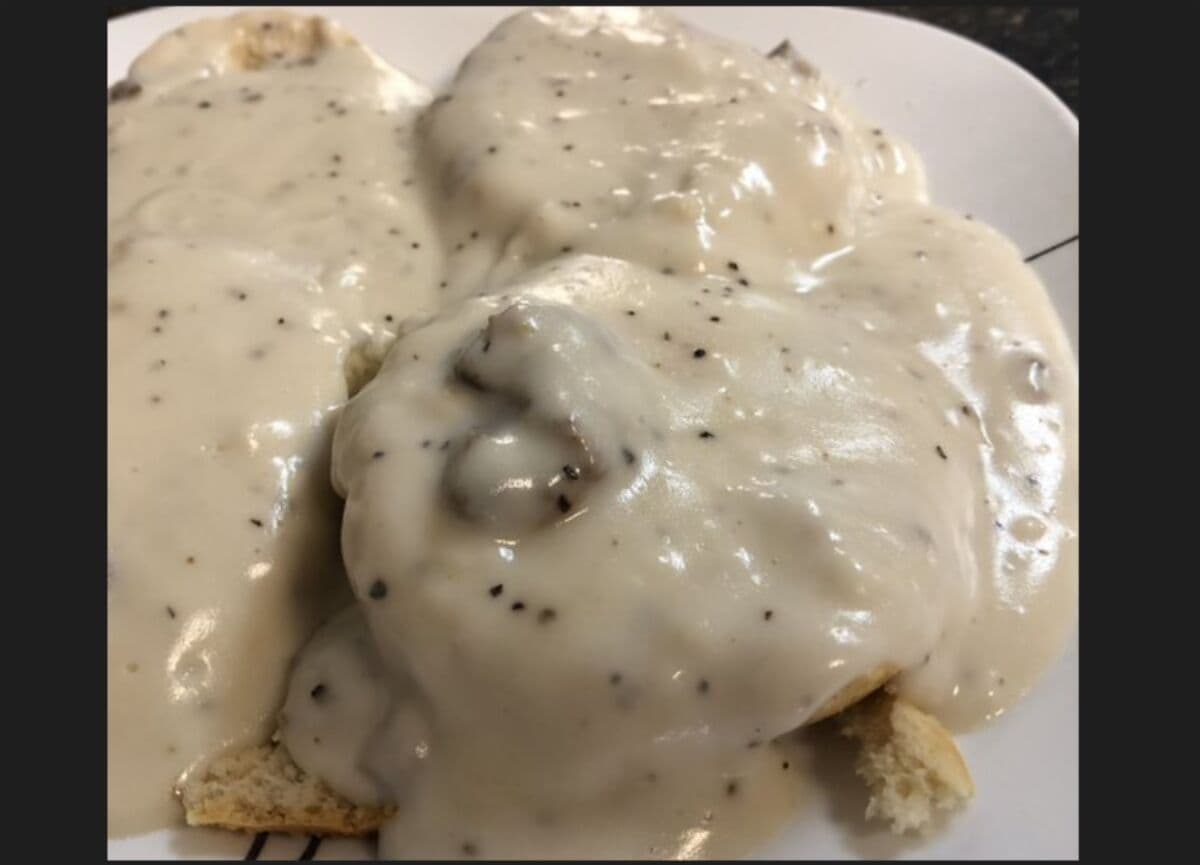 Biscuit and sausage gravy with eggs and bacon at Funny Pages Cafe