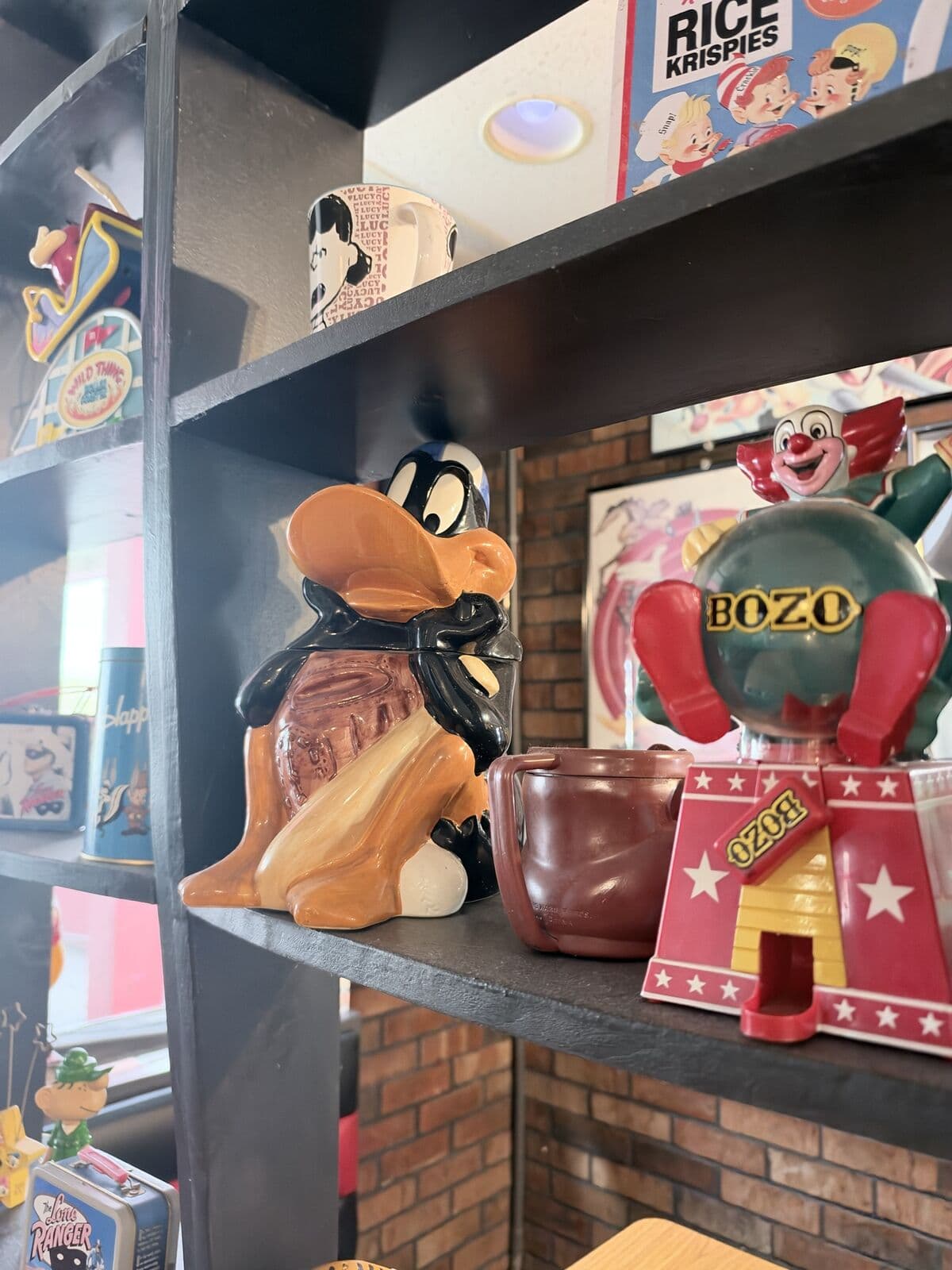 Vintage cartoon cookie jars and figures on the shelves
